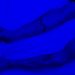 Close-up of tattooed arms grasping a white bedsheet under blue lighting, depicting anxiety and tension.